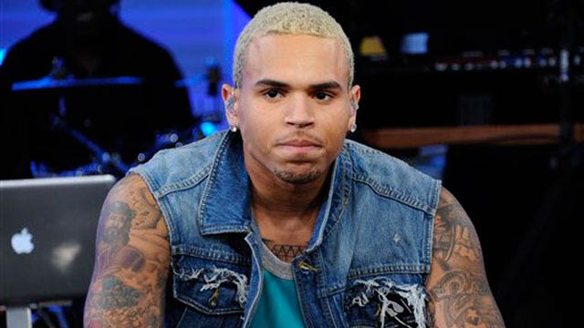 Chris Brown looking unhappy during an interview