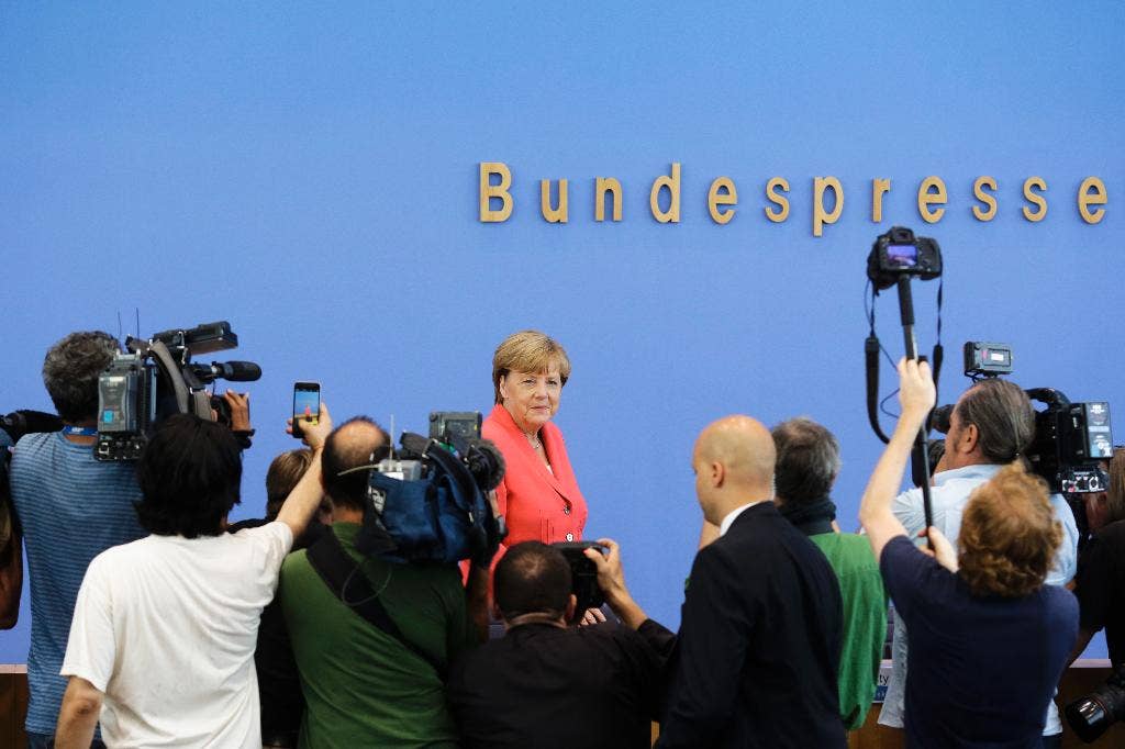 Germany's Merkel presses for other EU countries to do more to share ...