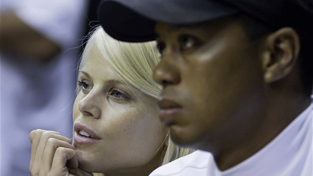 FILE: Tiger Woods and wife Elin Nordegren are seen talking in this June 11, 2009 photo during the first quarter of the NBA finals in Orlando, Fla. (AP)