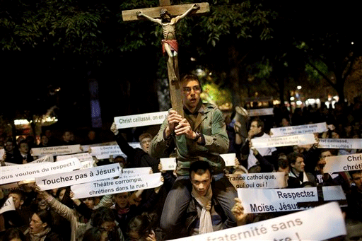 Oct. 27: A Christian activist holds a crucifix during a demonstration in front of the Theatre de la ville in Paris.