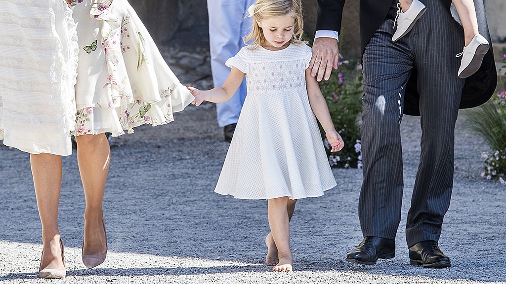 Sweden's Princess Madeleine, left holding Prince Nicolas stands next to her  husband Christopher O'Neill holding their daughter Princess Leonore, with  Queen Silvia and King Carl XVI Gustaf at right, during the christening