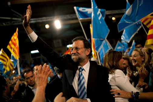Nov 16: Popular Party presidential candidate Mariano Rajoy waves to supporters during a campaign meeting for general elections in Hospitalet, on the outskirts of Barcelona, Spain.
