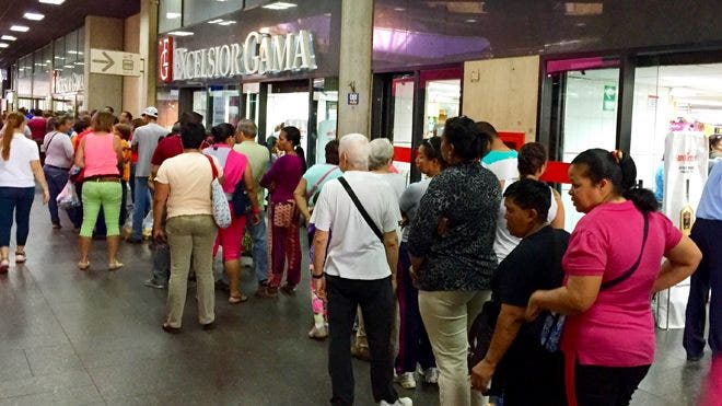 Despite government efforts, Venezuelans still spend long hours waiting for goods