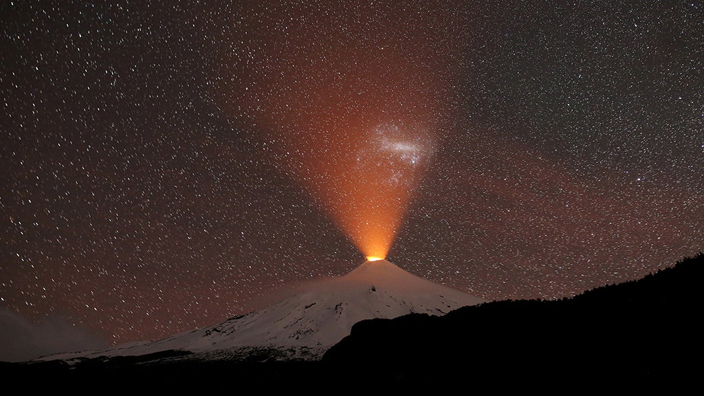 Volcano lights up snowy sky in stunning photo