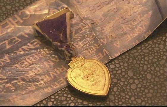 Purple Heart spotted on airport baggage claim belt finds its family