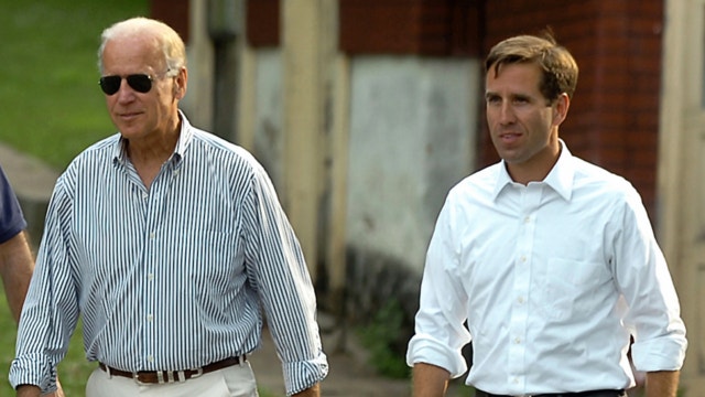 FILE: July 4, 2012: Delaware Attorney General Beau Biden, right, takes a walk with his father,Vice President Joe Biden, to the Green Ridge Little Baseball Field in Scranton, Pa. 
