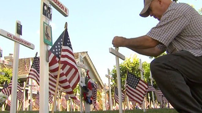 Homeowner fills yard with Memorial Day flags, crosses honoring fallen heroes