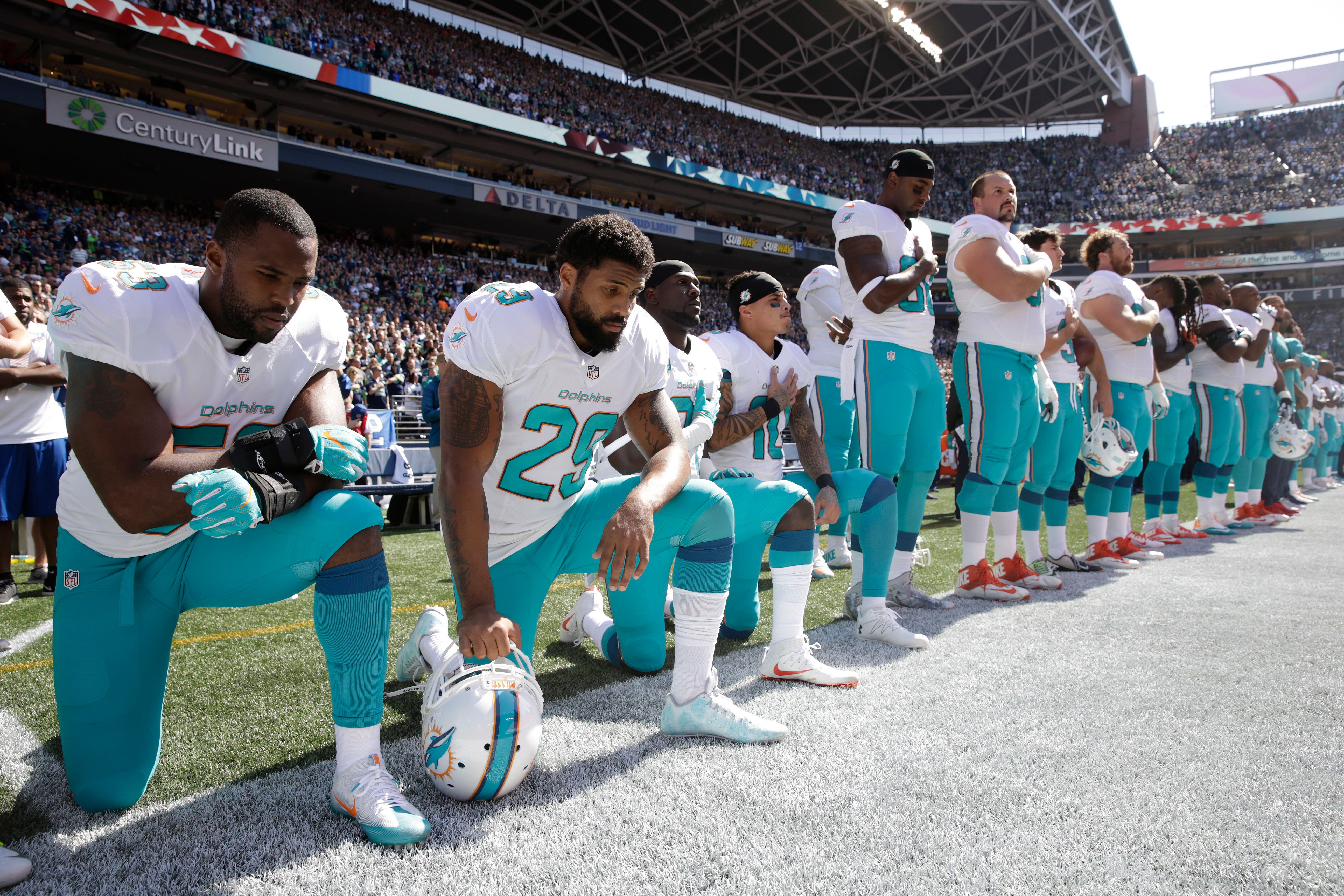 Dolphins players kneel during National Anthem, Seahawks lock arms