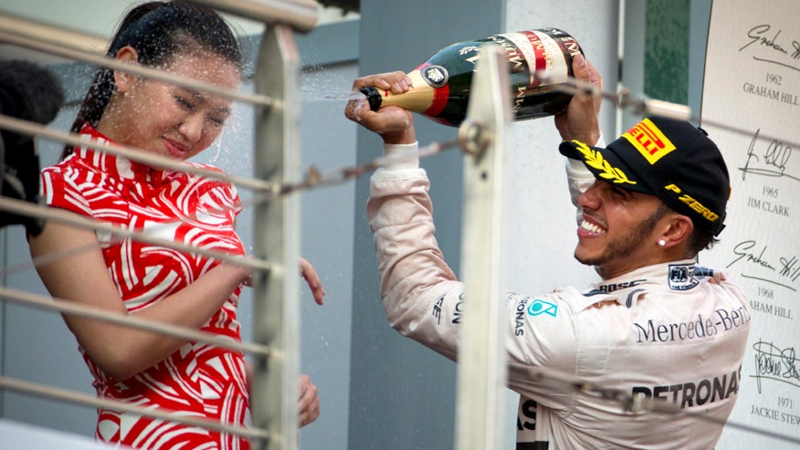 F1 star Lewis Hamilton defends his Champagne celebration after ...