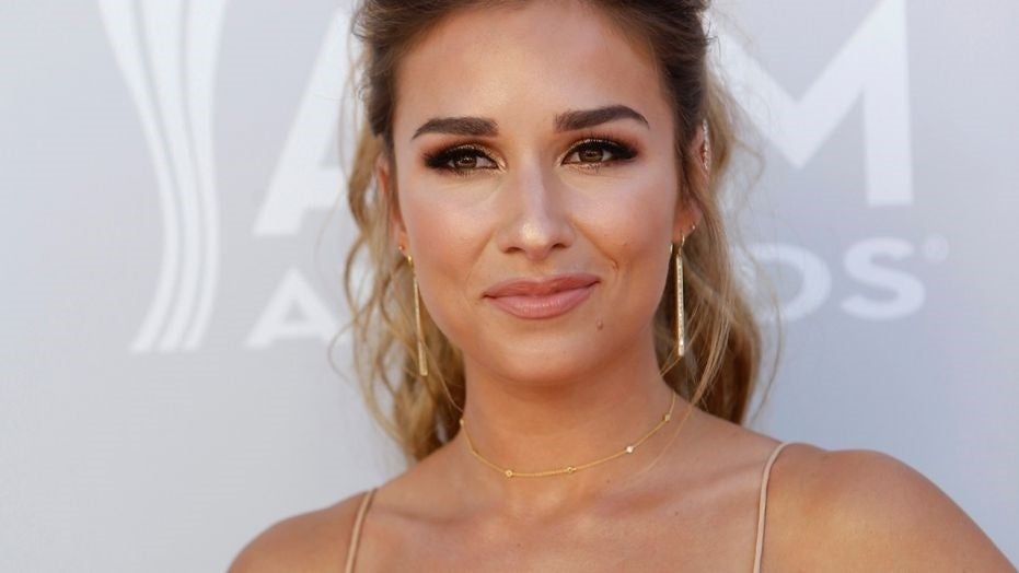Jessie James Decker defends posing with a glass of wine while breastfeeding infant son