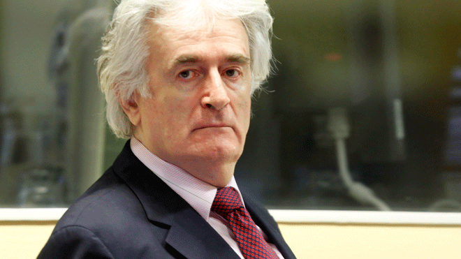 In this Nov. 3, 2009 file photo former Bosnian Serb leader Radovan Karadzic enters the courtroom of the U.N.'s Yugoslav war crimes tribunal in The Hague, Netherlands.