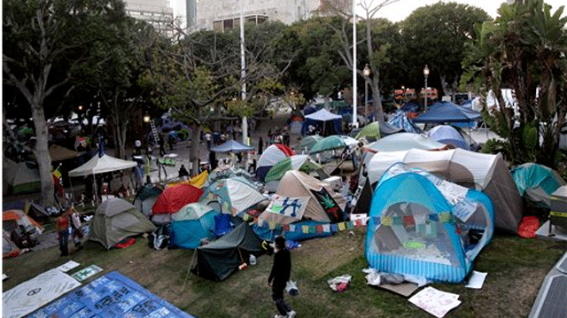 Nov. 2, 2011: Occupy Los Angeles protester walks past tents set up outside Los Angeles City Hall in Los Angeles.