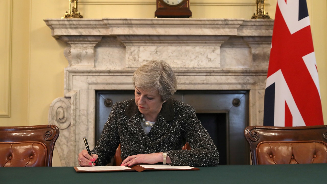 Brexit: UK PM Theresa May signs Article 50 letter with call to 'come together'
