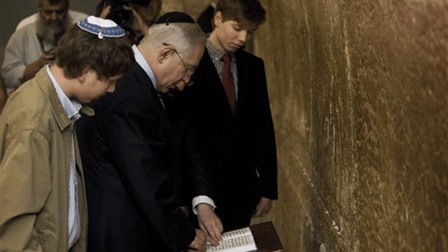 April 1, 2009: Israeli Prime Minister Benjamin Netanyahu reads from a prayer book as he stands with his sons Yair, right, and Avner at the Western Wall in the Old City of Jerusalem. An Israeli paper said Friday, June 24, 2011, the Israeli prime minister's son posted offensive comments about Arabs and Muslims on his Facebook page.