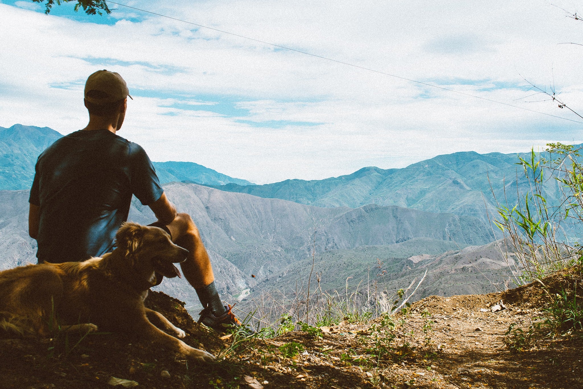 He his dog. Stridinq across the open countryside with his Dog.