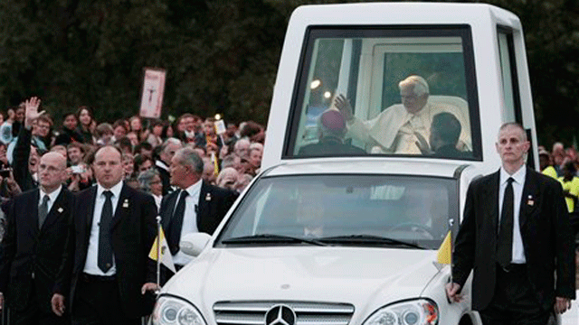 Sept. 18, 2010: Pope Benedict XVI, followed by security guards, arrives aboard the popemobile in Hyde park to attend a Vigil prayer in London. PETA, an animal rights group, has urged Pope Benedict XVI to "truly go green" and insist that the next popemobile is made without leather.