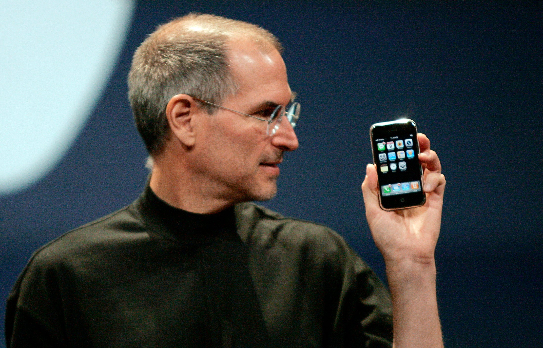 Apple Computer Inc. Chief Executive Officer Steve Jobs holds the new iPhone in San Francisco, California January 9, 2007. Apple unveiled an eagerly-anticipated iPod mobile phone with a touch-screen on Tuesday, priced at $599 for 8 gigabytes of memory, pushing the company's shares up as much as 8.5 percent. Jobs said the iPhone, which also will be available in a 4-gigabyte model for $499, will ship in June in the United States. The phones will be available in Europe in the fourth quarter and in Asia in 2008. REUTERS/Kimberly White (UNITED STATES) FOR BEST QUALITY IMAGE SEE: GM1E7AE0B8F01 - RTR1L0YV