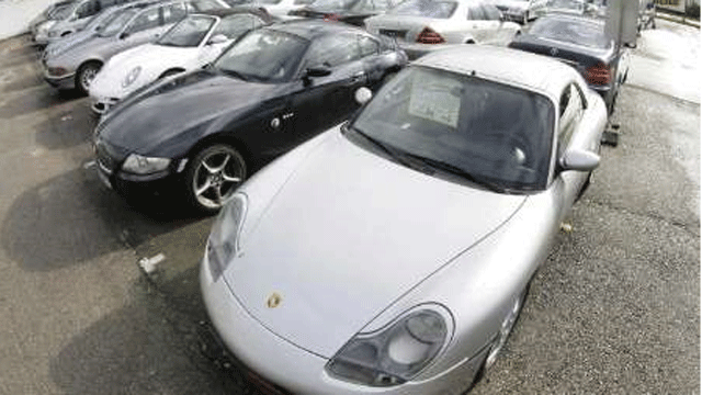 A variety of used cars are for sale at a car dealership.
