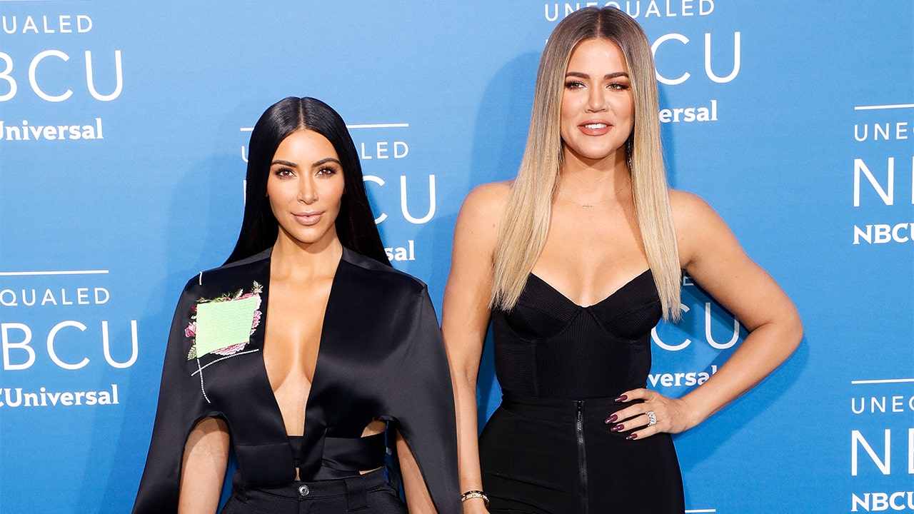 Kim Kardashian dyes her hair red while sister Khlo goes back to