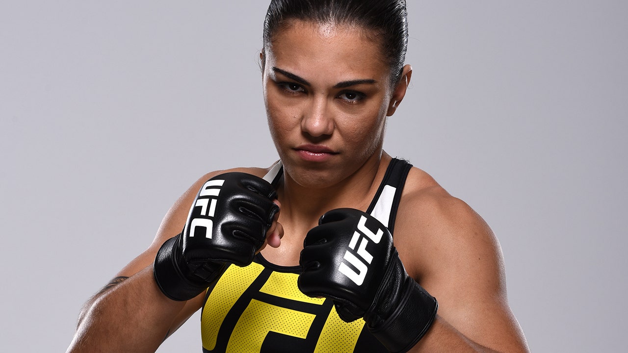 UFC champion Jessica Andrade poses nude with title belt.