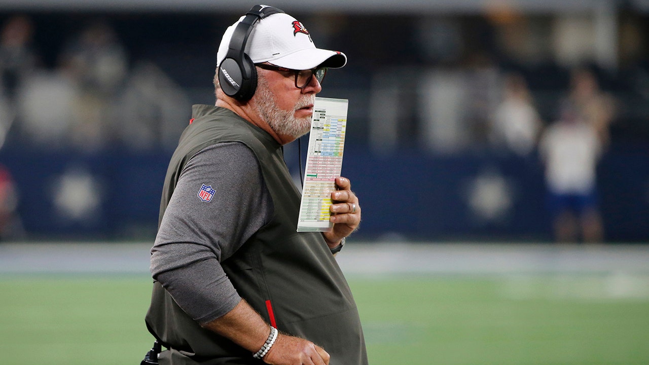 Bruce Arians looks like many things with face shield, headset and hat