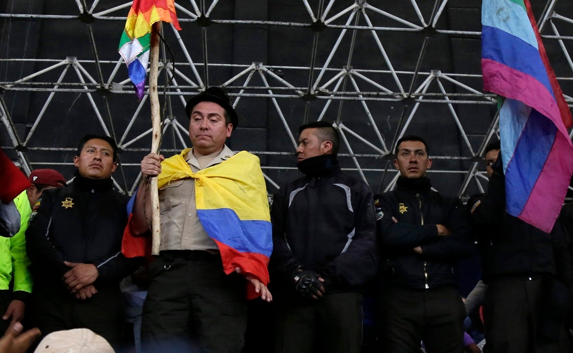 Ecuadorian anti-government protesters show off captive police officers