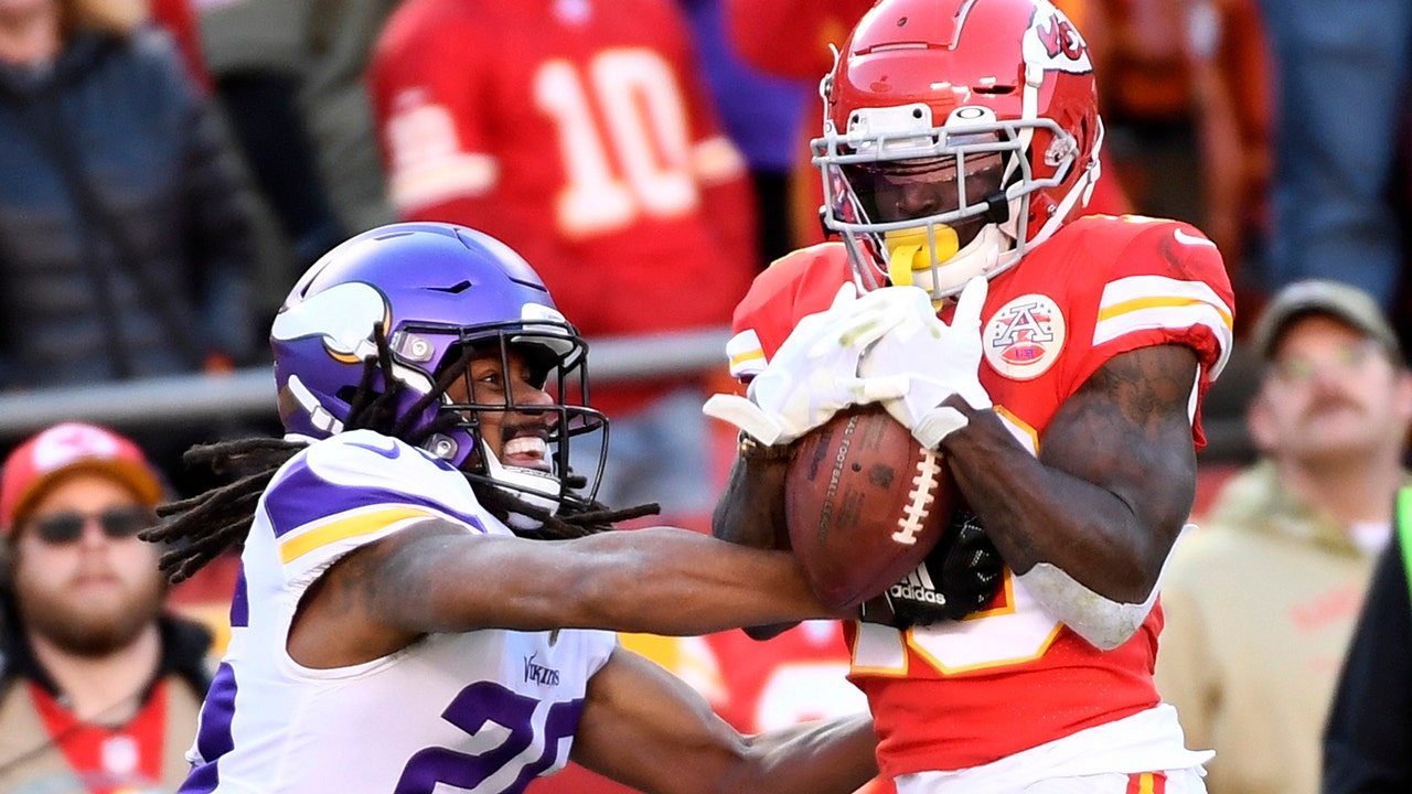 Wide receiver Tyreek Hill #10 of the Kansas City Chiefs makes a catch in  front of linebacker …