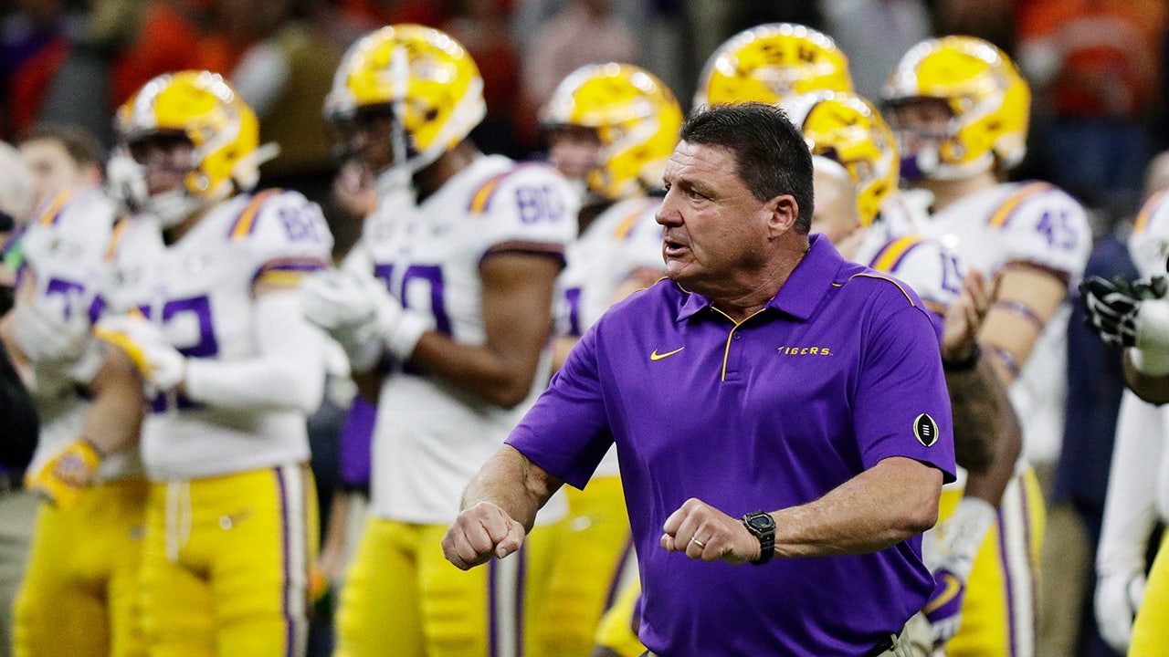 Former LSU head football coach, Ed Orgeron, right, talks to his