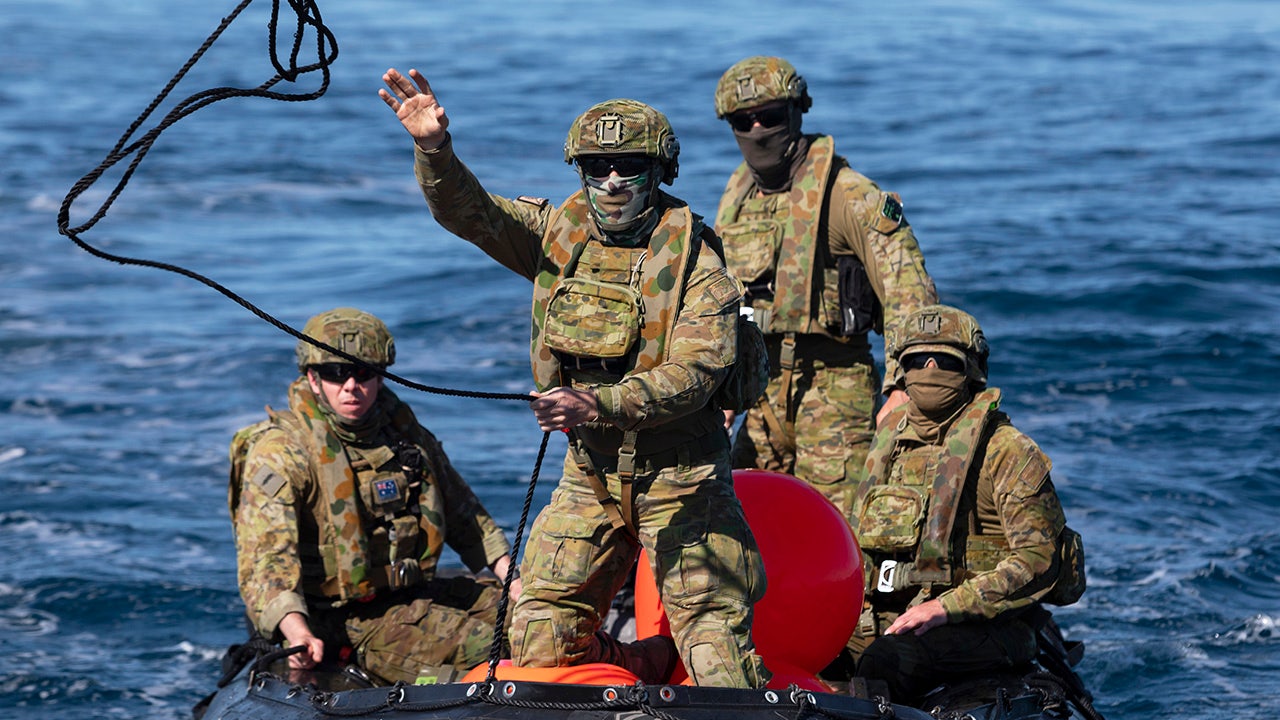 Australian Navy divers find unexploded bomb on reef, tow it to sea