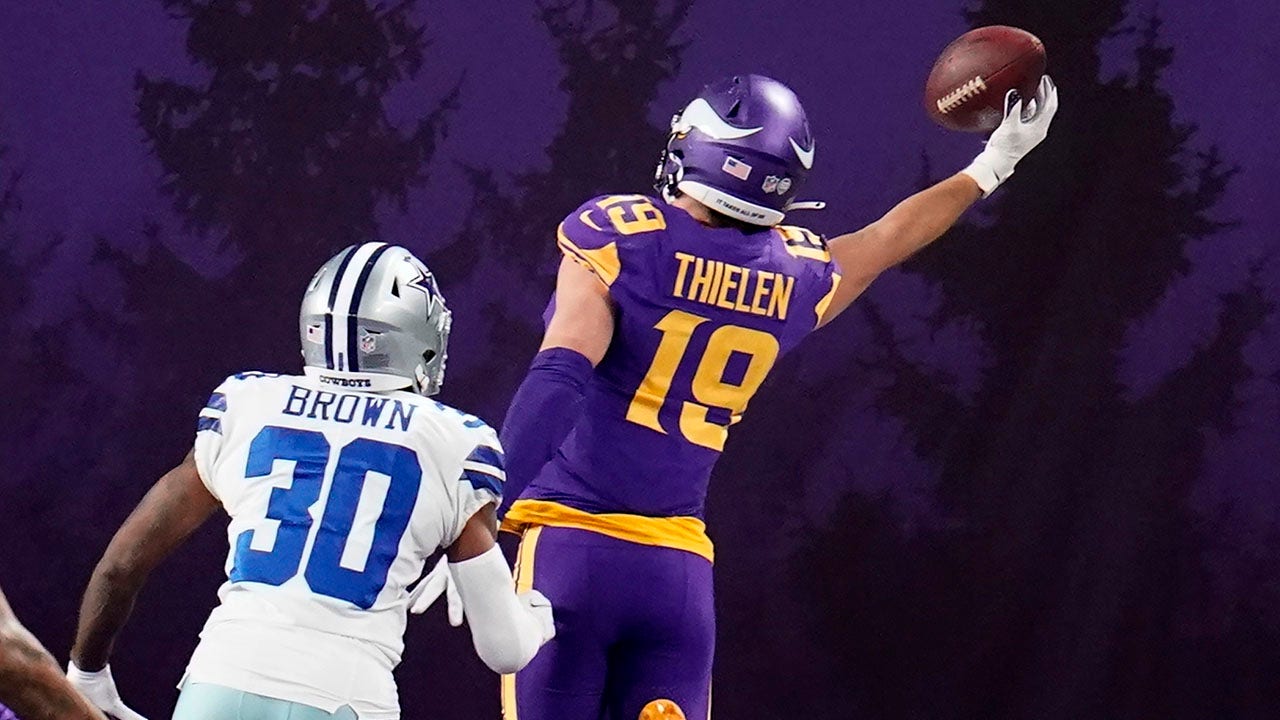 NFC wide receiver Adam Thielen (19), of the Minnesota Vikings, scores a  touchdown as AFC defensive back A.J. Buoy (21), of the Jacksonville Jaguars  defends, during the first half of the NFL