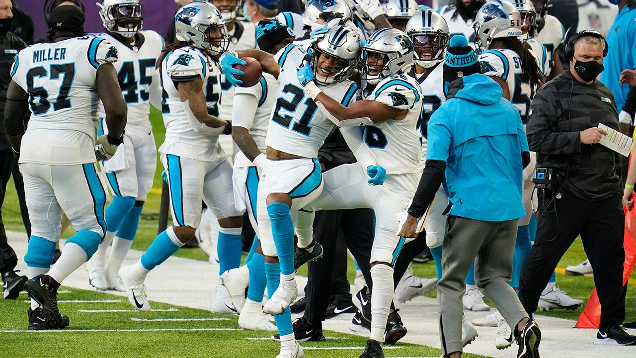 CHARLOTTE, NC - SEPTEMBER 25: Jeremy Chinn (21) of the Carolina Panthers  heads back to the the huddle after breaking up a pass attempt during a  football game between the Carolina Panthers