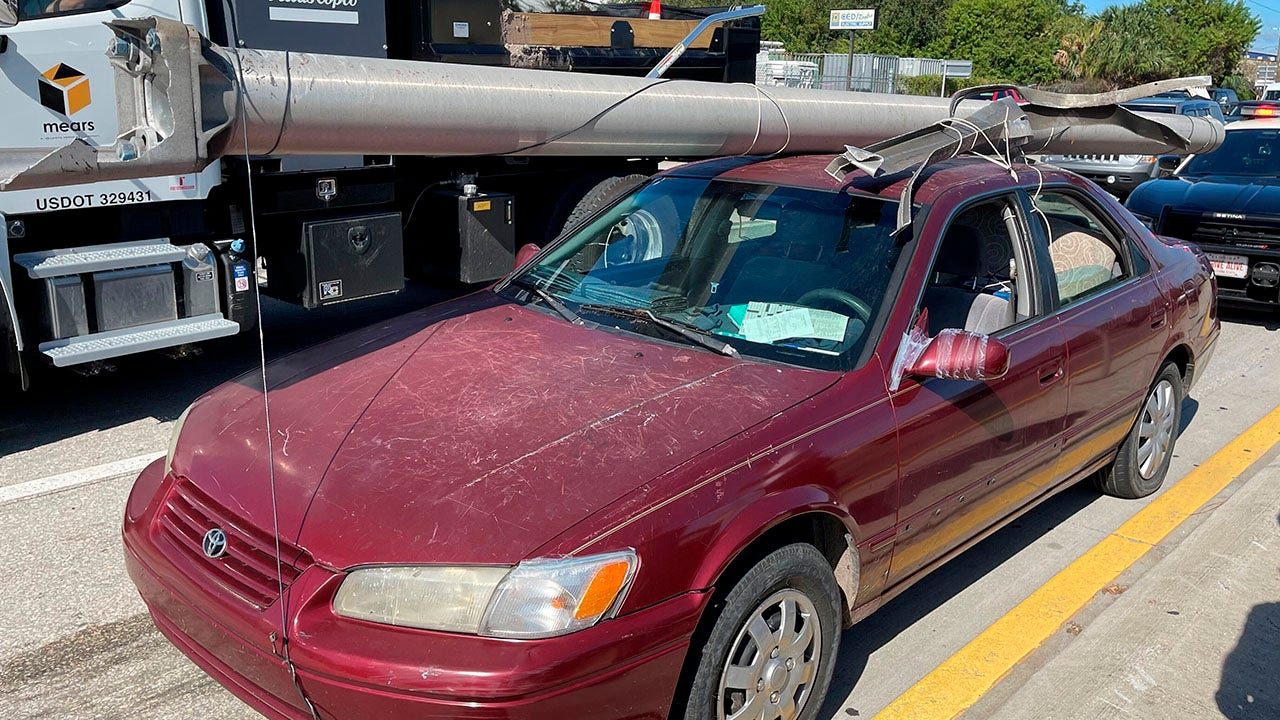 Florida man arrested after strapping downed light pole to car roof on highway