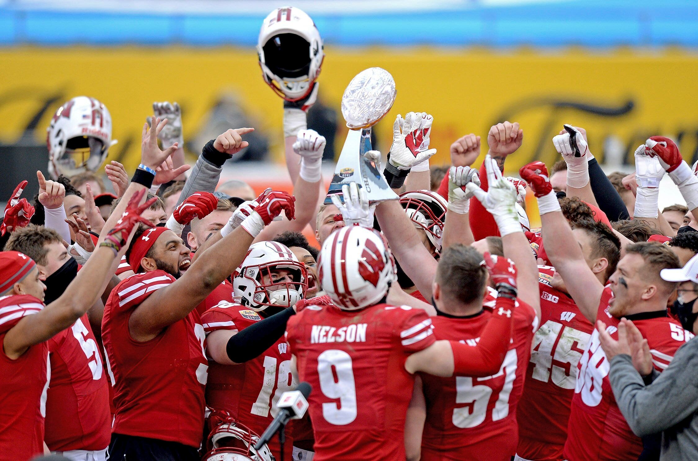 Wisconsin Badgers QB trumps the trophy of the pickup and hits it on the floor, videos show