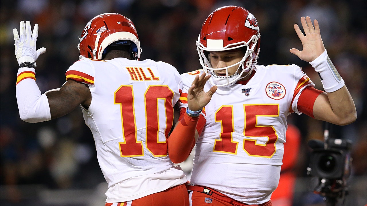 Kansas City Chiefs' Tyreek Hill, top, makes a catch during the