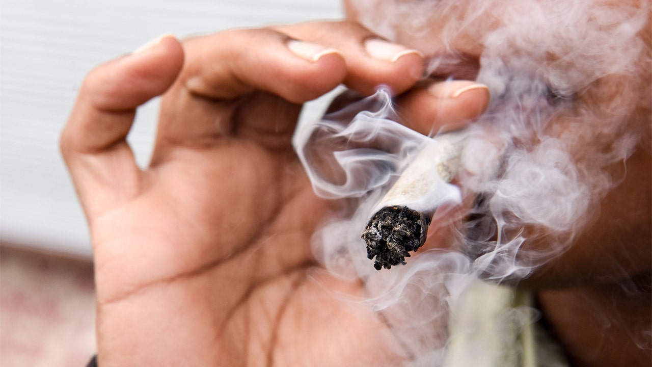 New York man smokes pot in front of two NYPD police officers in celebration of legal marijuana