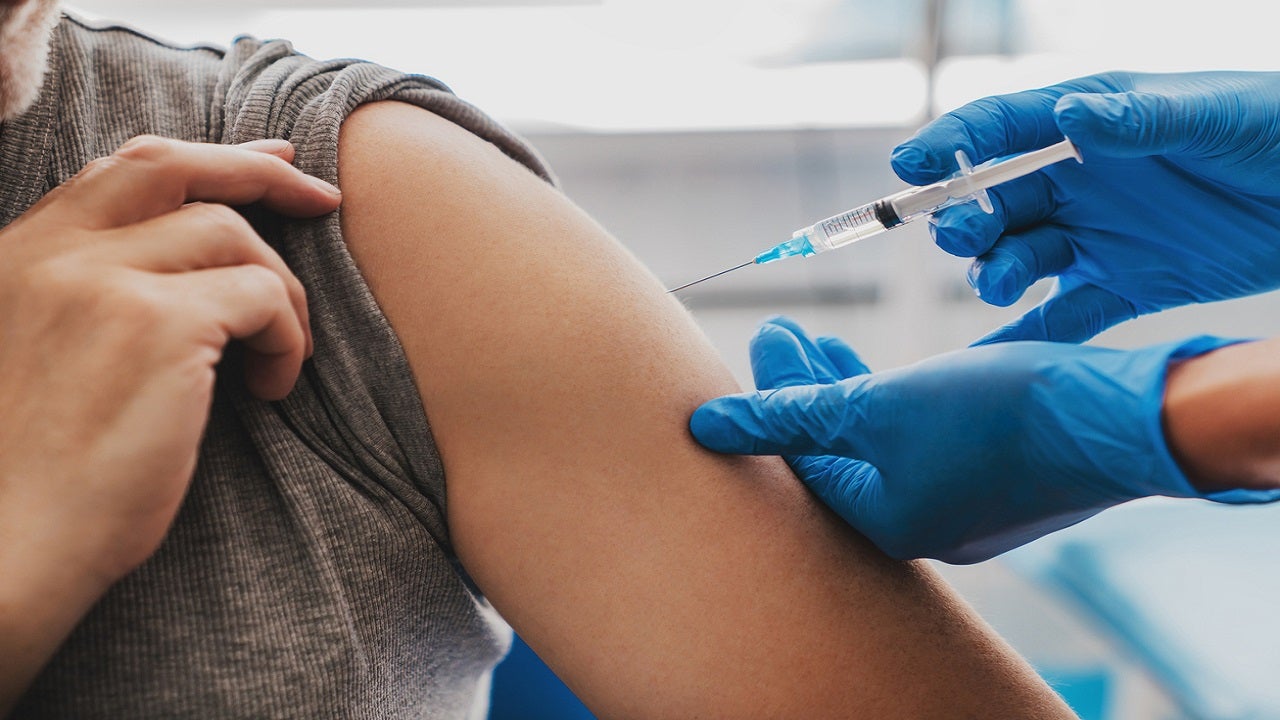 Colorado woman waiting for COVID-19 vaccine with empty syringe