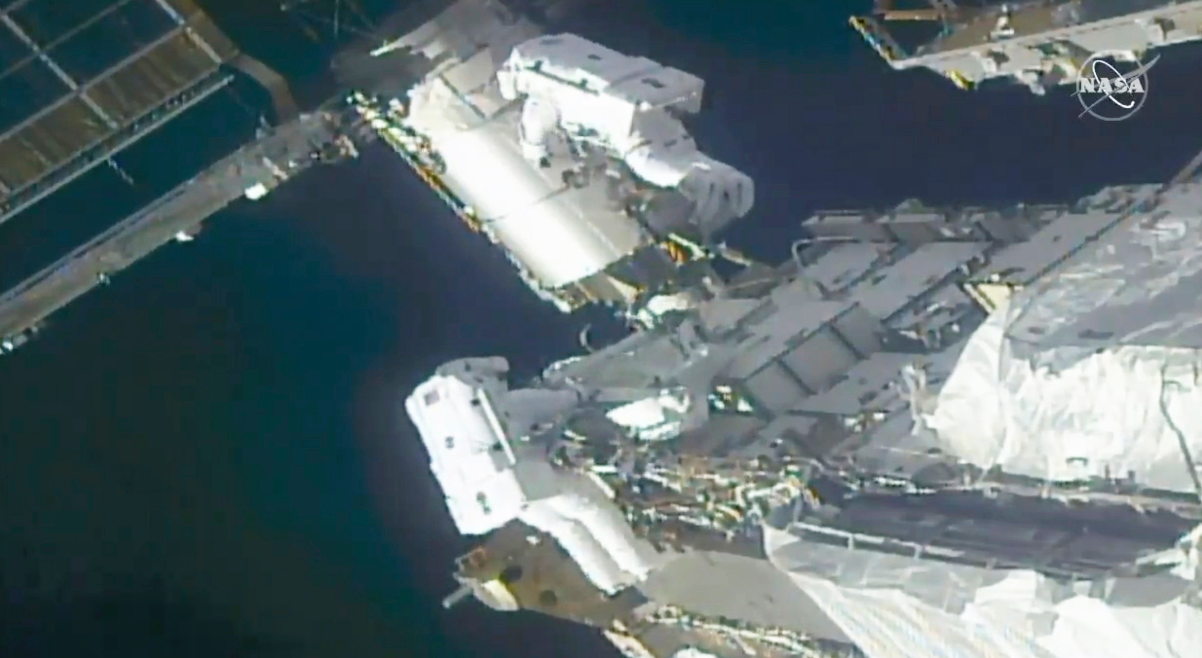 Spacewalking astronauts prep station for new solar wings