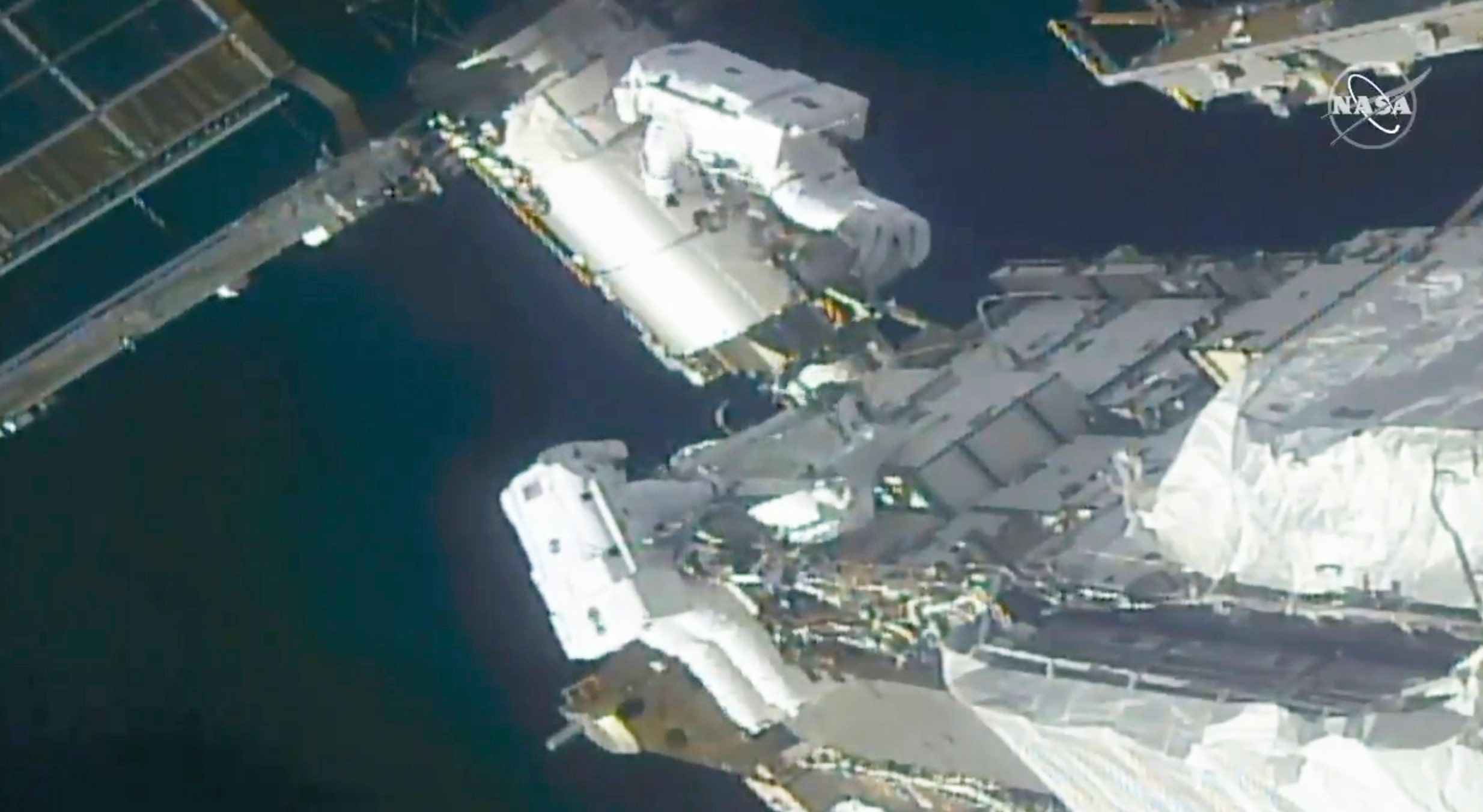 Spacewalking astronauts prepare for new sun wings