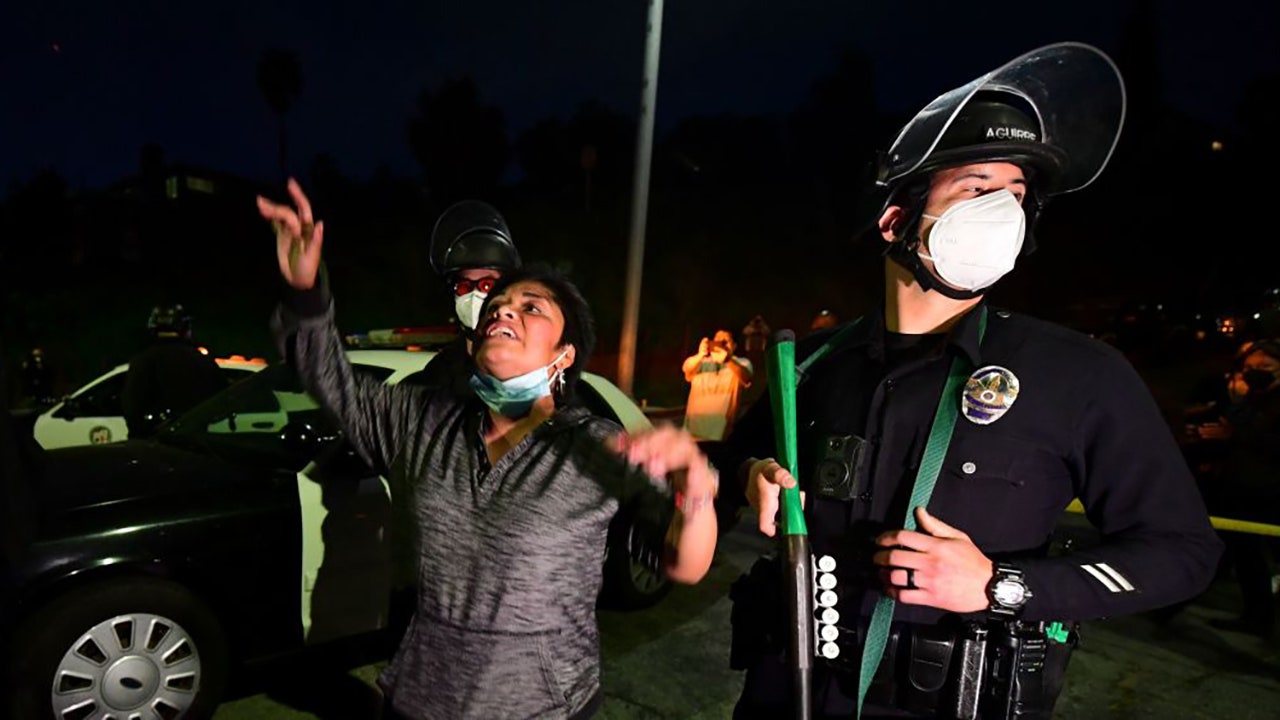 LA police clash with protesters at Echo Park homeless encampment