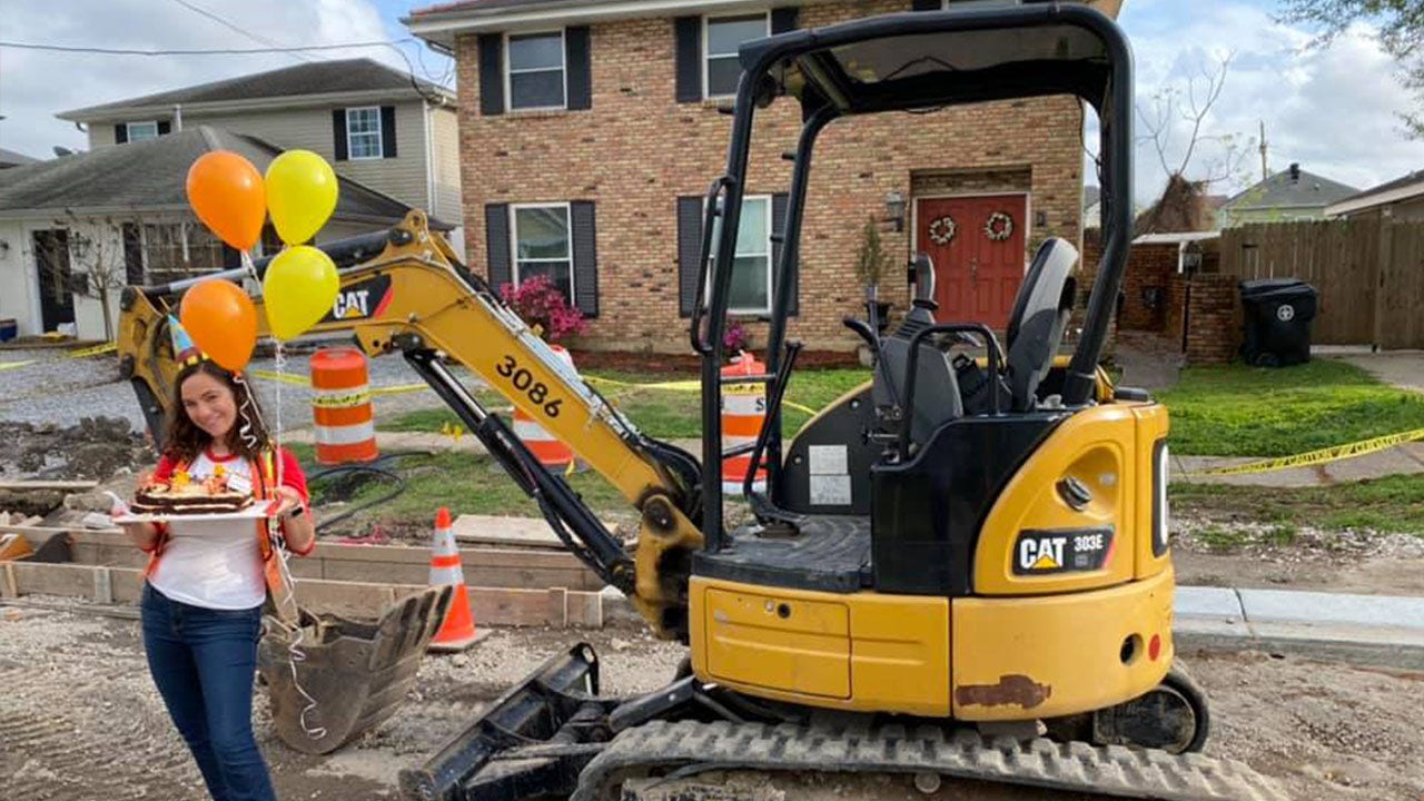 Woman celebrates year of unfinished construction in front of New Orleans home