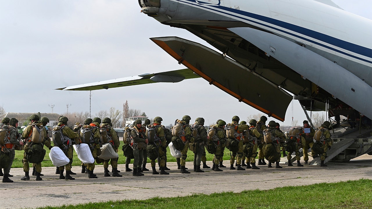 Russia orders troop pullback, but keeps weapons near Ukraine