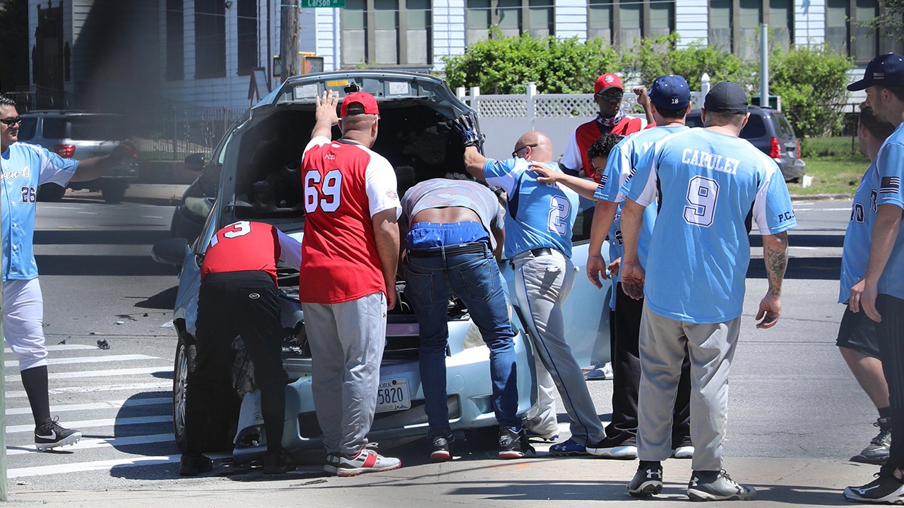 NYPD officers pause softball game to help woman who got in a car crash