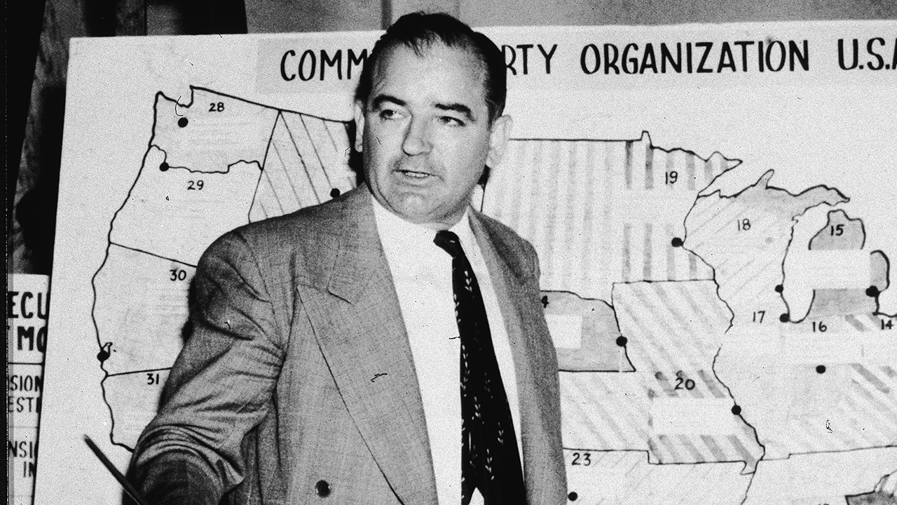 American politician Joseph McCarthy, Republican senator from Wisconsin, testifies against the US Army during the Army-McCarthy hearings, Washington, DC, June 9, 1954. McCarthy stands before a map which charts Communist activity in the United States.