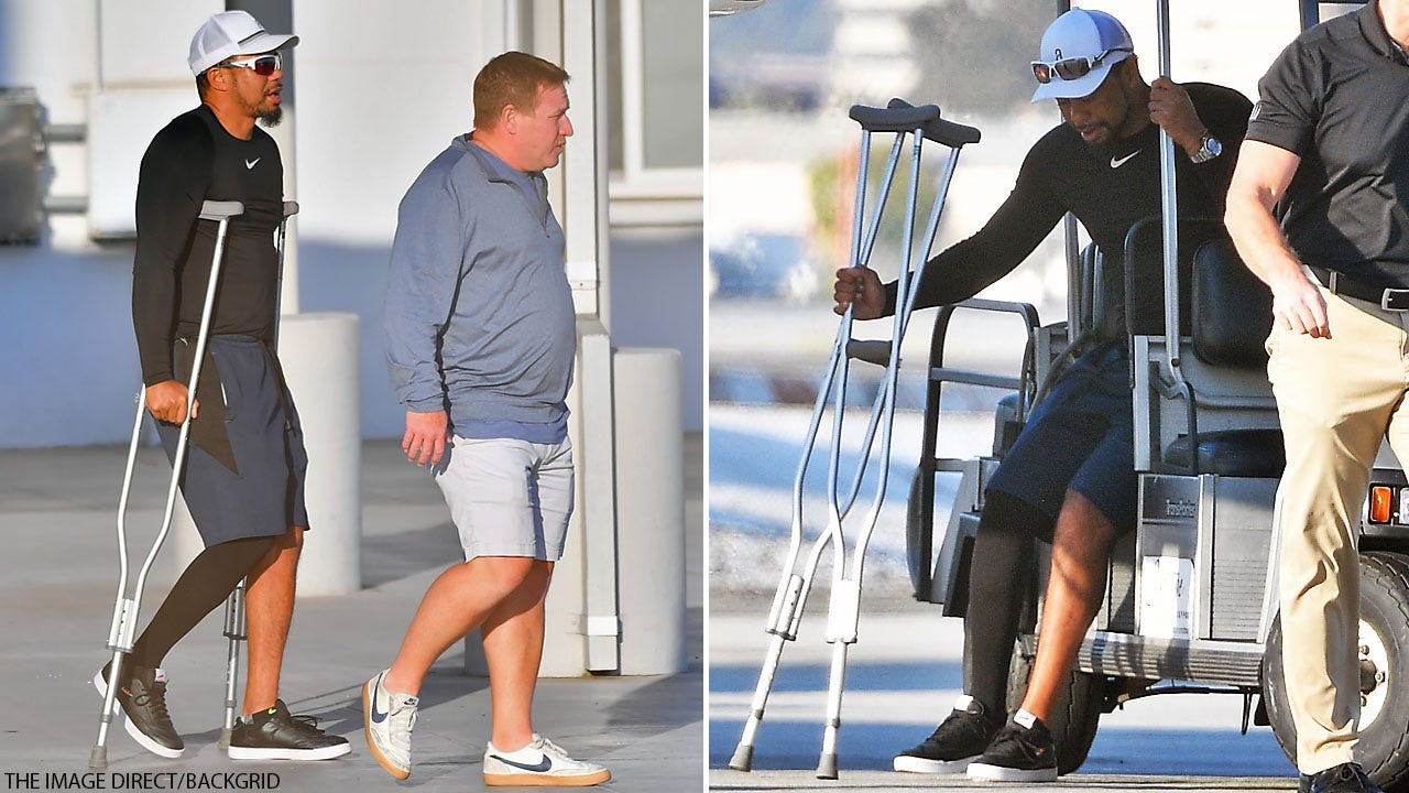 Tiger Woods seen on crutches as he arrives in Los Angeles, presumably ...