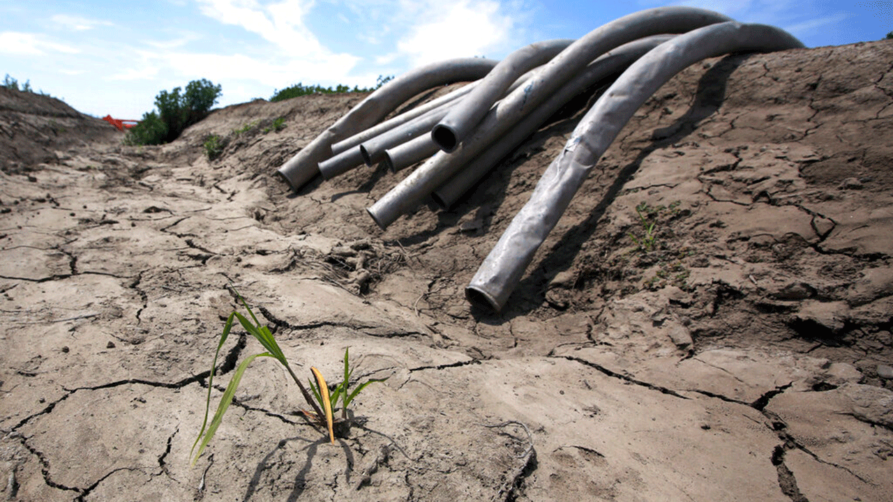 FILE - In this May 18, 2015 file photo, irrigation pipes sit along a dry irrigation canal on a field near Stockton, Calif. 