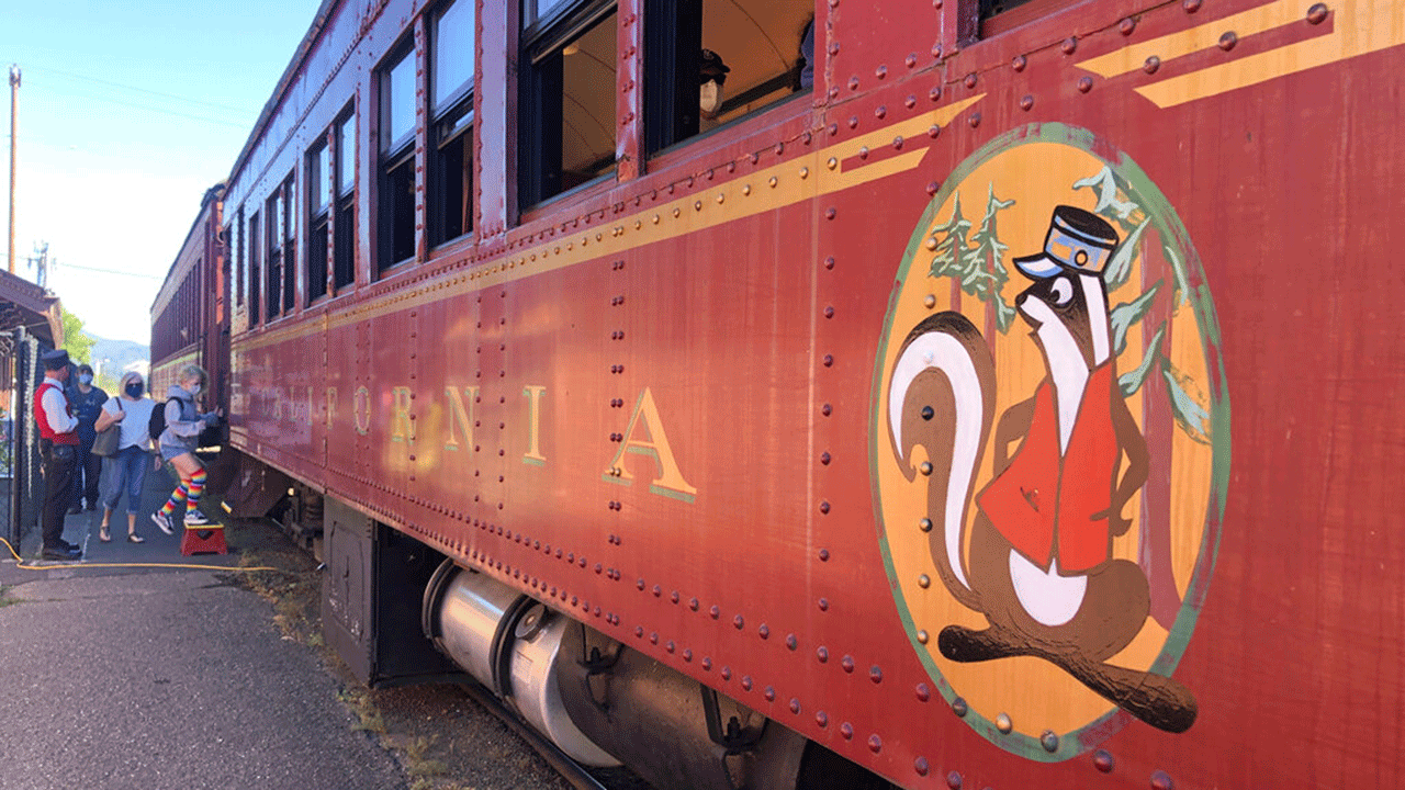 People board the Skunk Train in Willits, Calif., Wednesday, Aug. 4, 2021. Tourists flock to the picturesque coastal town of Mendocino for its Victorian homes and cliff trails, but visitors this summer will also find public portable toilets and dozens of signs on picket fences announcing the quaint Northern California hamlet: "Severe Drought Please conserve water."