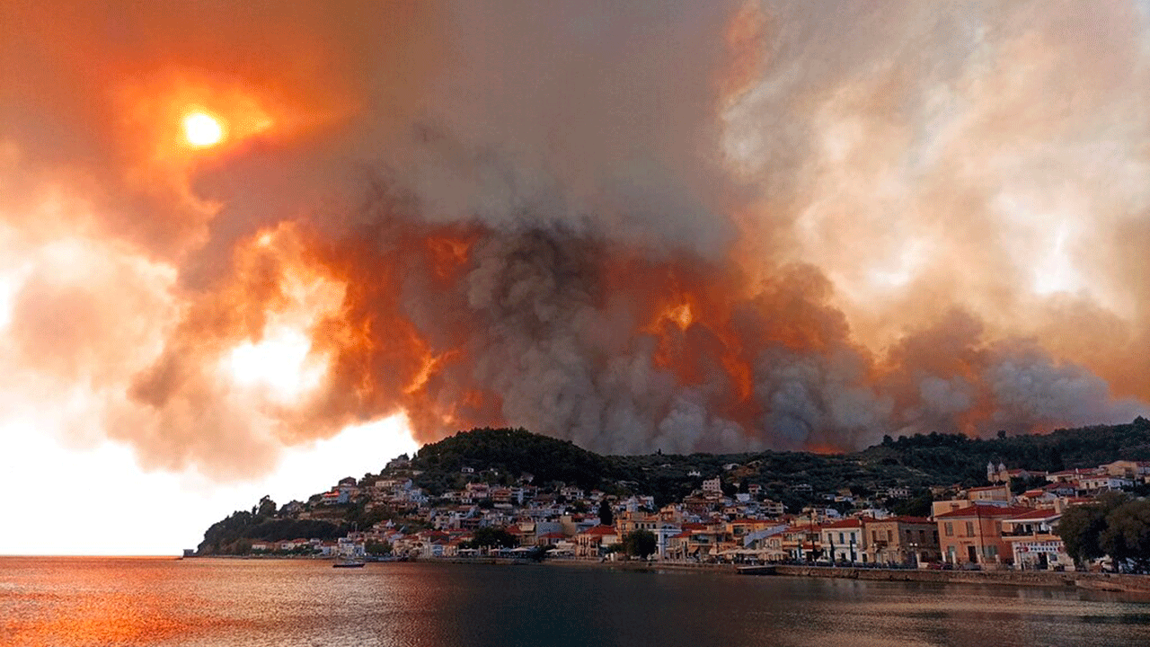 Flames burn on the mountain near the village of Limni on the island of Evia, about 160 kilometers (100 miles) north of Athens, Greece on Tuesday, August 3, 2021. Greece was struggling on Tuesday. the worst heat wave in decades that strained the national power supply and fueled forest fires near Athens and elsewhere in southern Greece.  As the heat wave searing the eastern Mediterranean intensified, temperatures reached 42 degrees Celsius (107.6 Fahrenheit) in parts of the Greek capital.