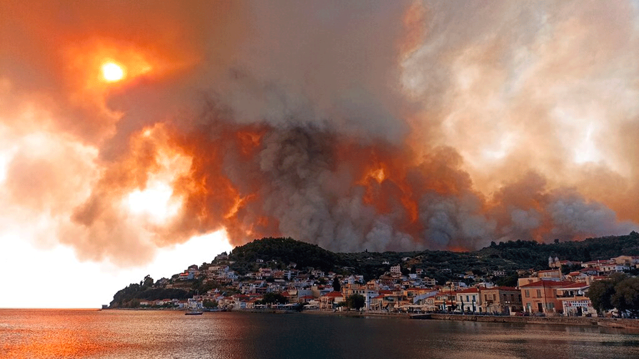 Flames burn on the mountain near Limni village on the island of Evia, about 160 kilometers (100 miles) north of Athens, Greece, Tuesday, Aug. 3, 2021. Greece Tuesday grappled with the worst heatwave in decades that strained the national power supply and fueled wildfires near Athens and elsewhere in southern Greece. As the heat wave scorching the eastern Mediterranean intensified, temperatures reached 42 degrees Celsius (107.6 Fahrenheit) in parts of the Greek capital.