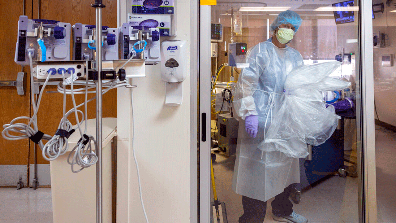 Kecia Harris, with the environmental services department, cleans the room of a patient fighting the coronavirus at Our Lady of Angels Hospital in Bogalusa, Louisiana, Monday, Aug. 9, 2021.