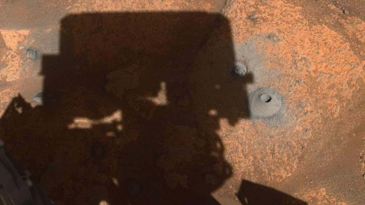 Perseverance's Navigation Camera Image of First Borehole: The drill hole from Perseverance’s first sample-collection attempt can be seen, along with the shadow of the rover, in this image taken by one of the rover’s navigation cameras.?